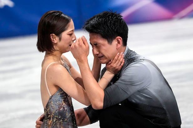 Japanese figure skating representative Kihara Ryuichi, right, bursts into tears after finishing the pair free skating performance, with partner Miura Riku warmly wrapping his face. /UPI-Yonhap