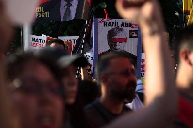 On the 7th, participants march at an anti-NATO summit protest in Istanbul. A sign displays an image of U.S. President Donald Trump with the phrase 'Murderous America'. /AP-Yonhap