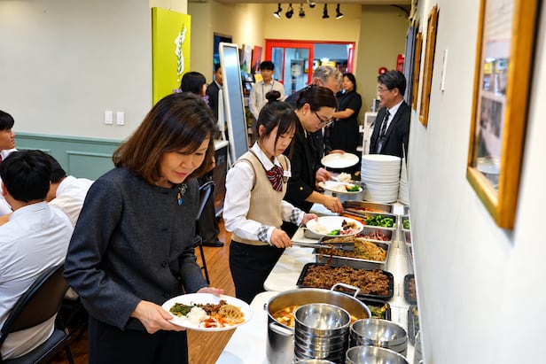 U.S. Ambassador to Korea Michelle Steel visits Jangdaehyun Middle and High School, an alternative school for North Korean defector youth in Busan, on the 23rd and places food on a plate for a lunch with students. /Courtesy of Jangdaehyun Middle and High School