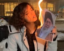 Woman Burning Hamei Photo Becomes Iran Protest Symbol