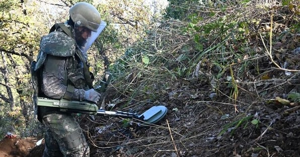 Soldiers conduct a joint field investigation in the DMZ after a suspected landmine explosion